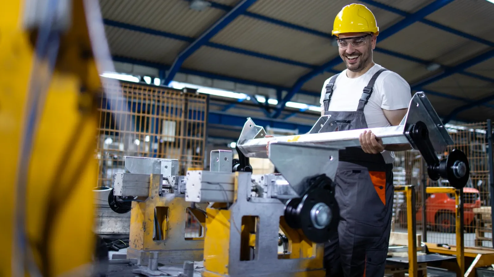 Worker at a machining station on a factory floor